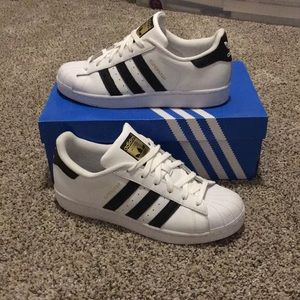 White with black adidas superstar sneakers